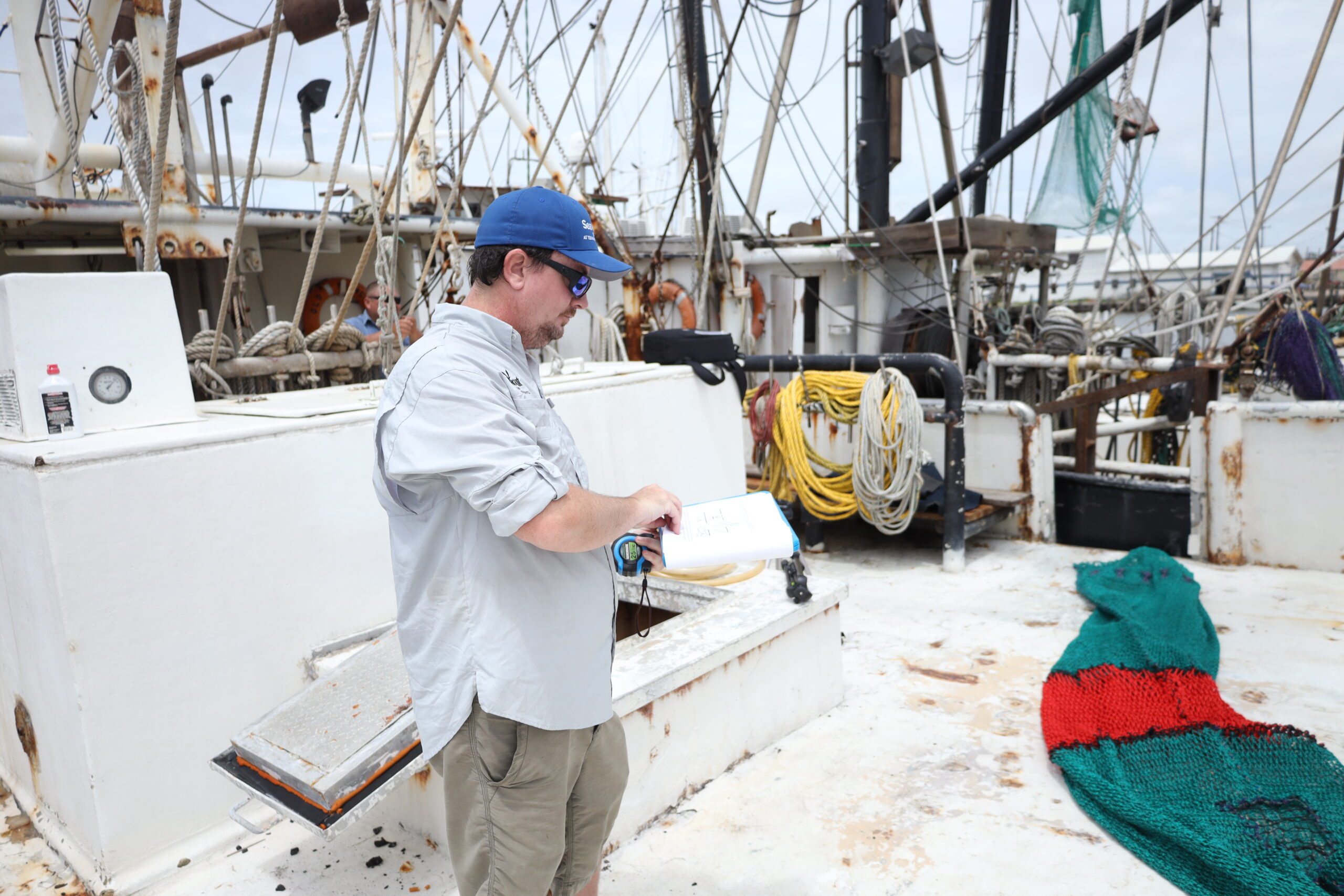 Matthew Kammann on a shrimp boat discussing BRD