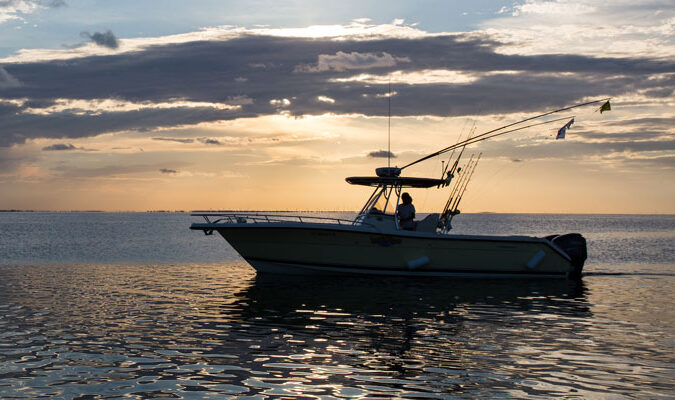 Boat cruising in the bay as a coastal monitor