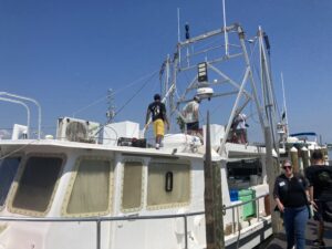 fishermen on the boat checking it