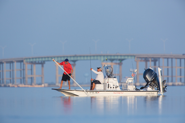 Men out on fishing boat in laguna madre bay