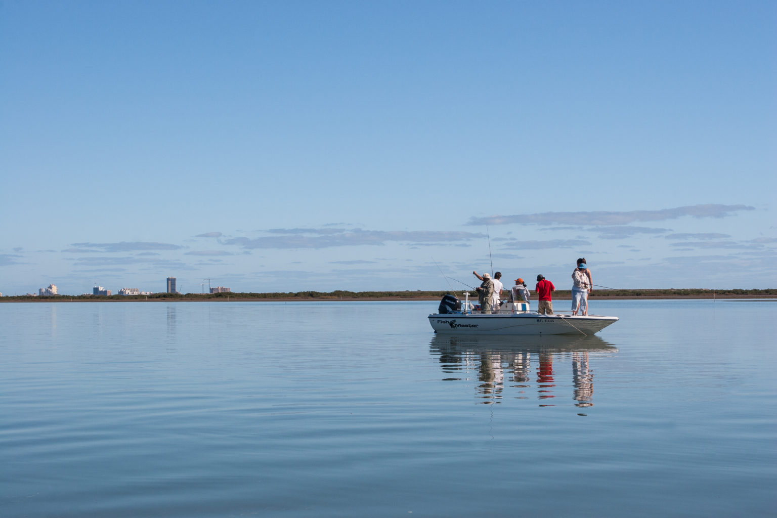 Guys on boat in water fishing