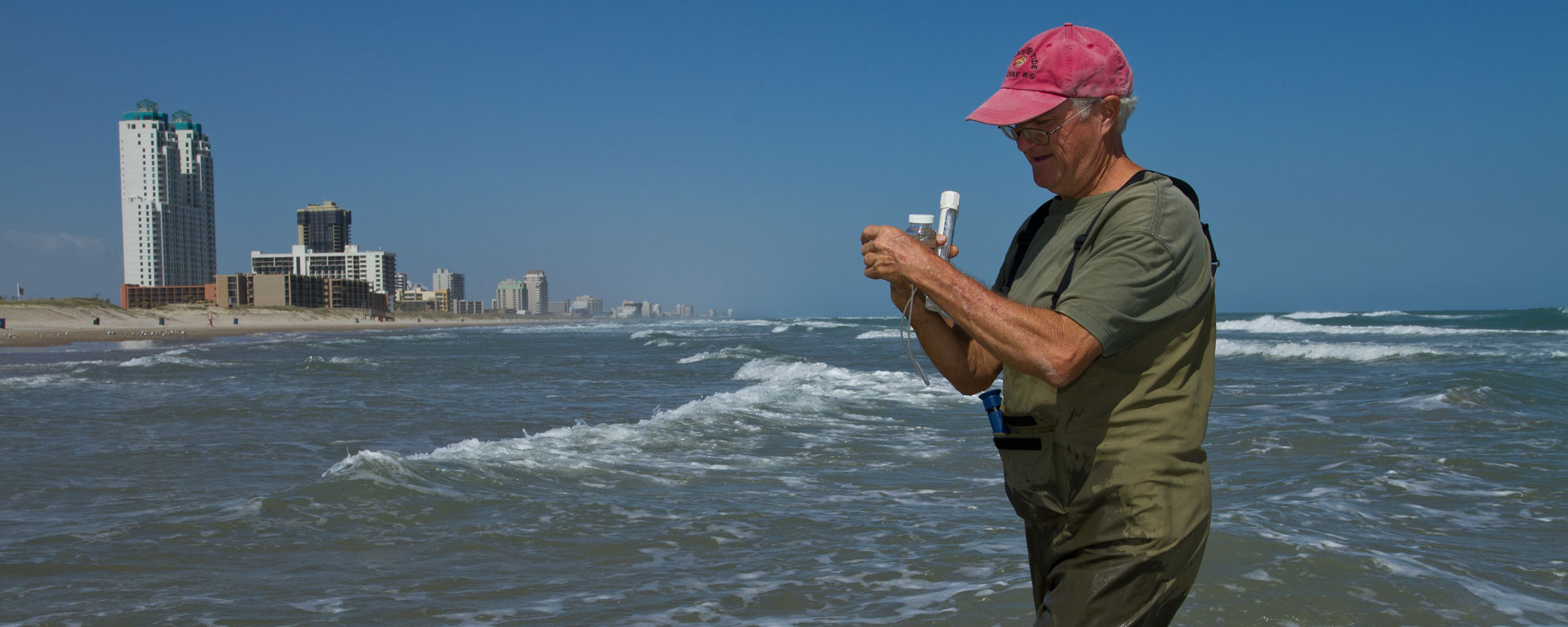 Red tide ranger collecting a sample for analysis South Padre Island, Texas