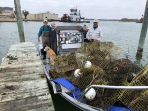 Crab trap cleanup boat and volunteers