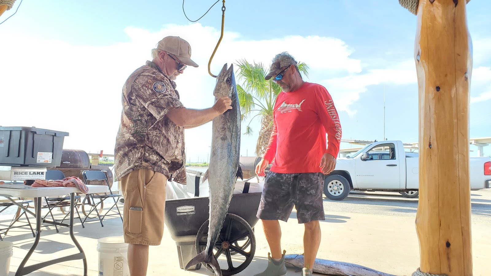 Weighmaster Kevin Burns examining a catch at the 2021 BACH Fishing Tournament in Surfside, TX.