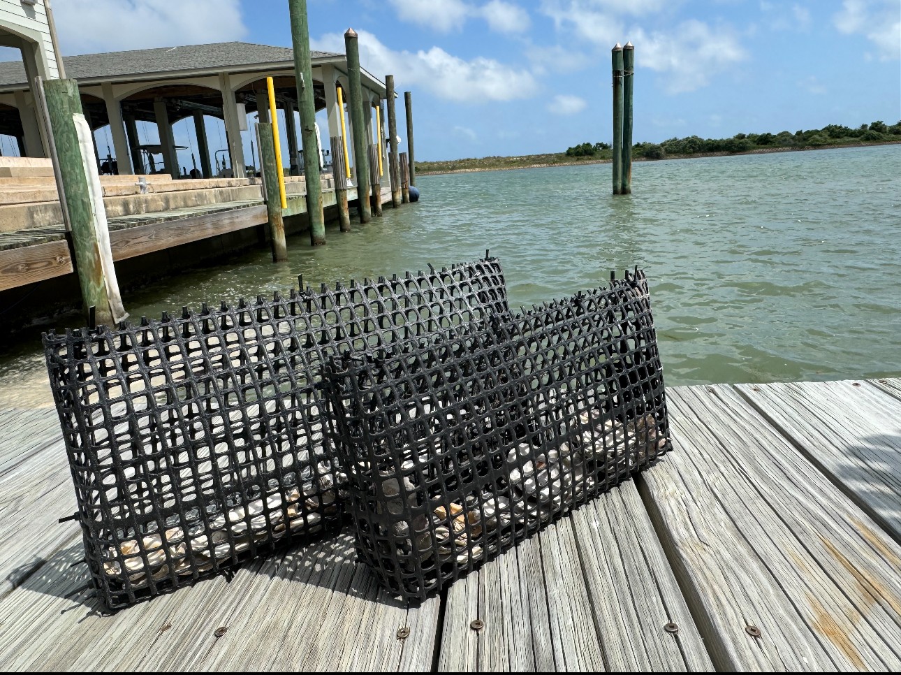 Two oyster cages on a pier