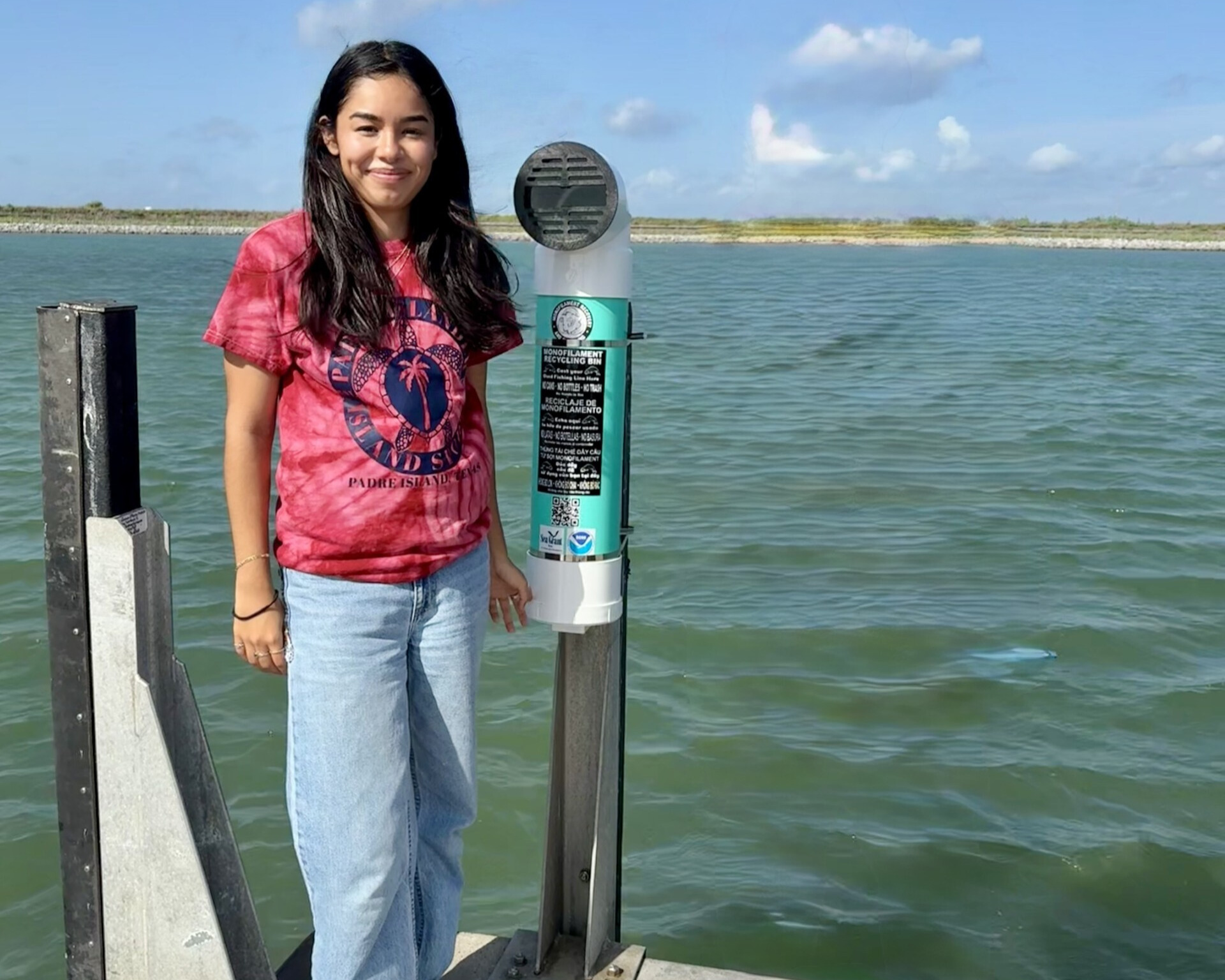 Rebecca Arcos with a monofilament recycling bin
