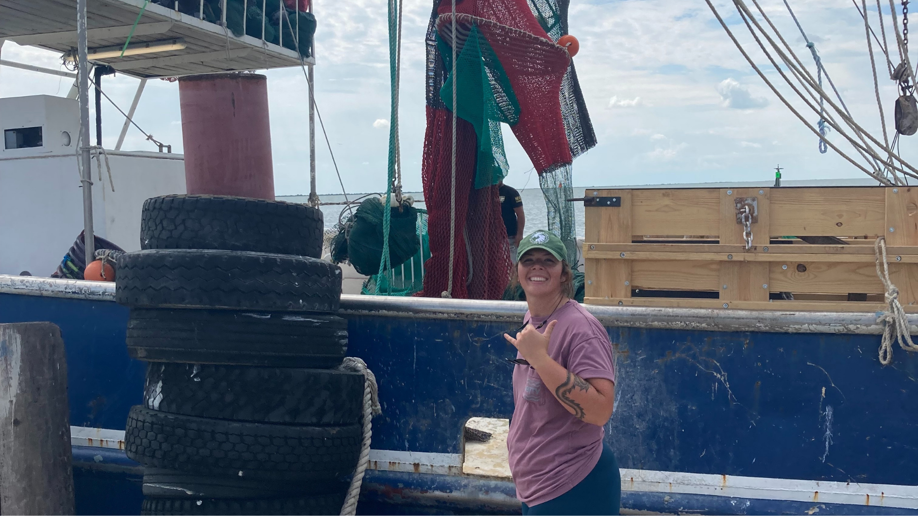 Sam Yasko in front of a shrimping vessel