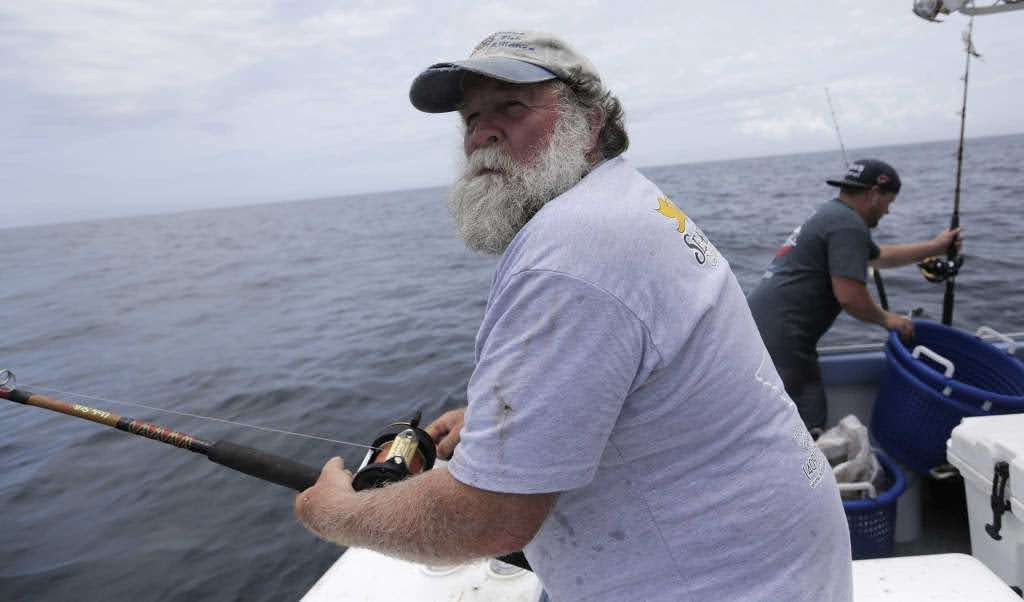 Buddy Guindon fishing from a boat
