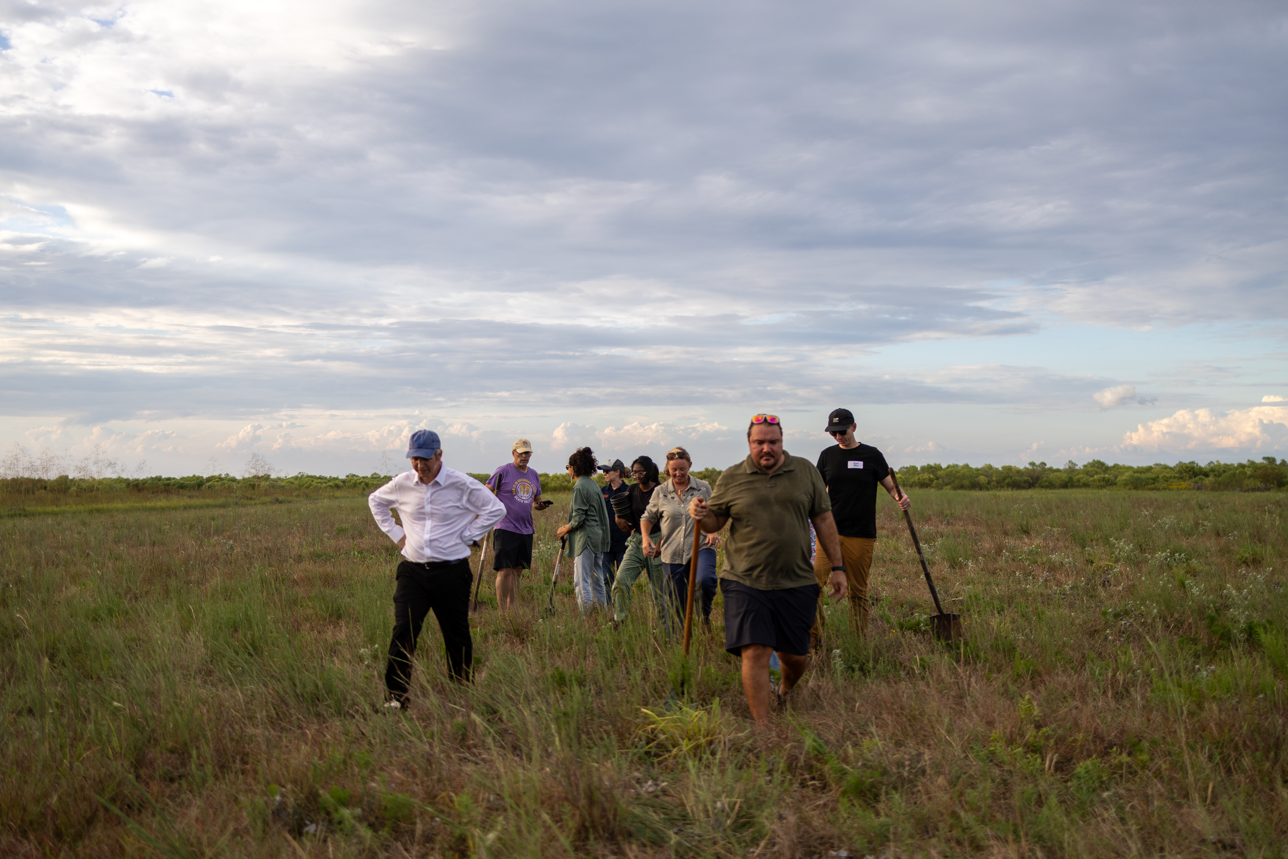 People walking through a field. 